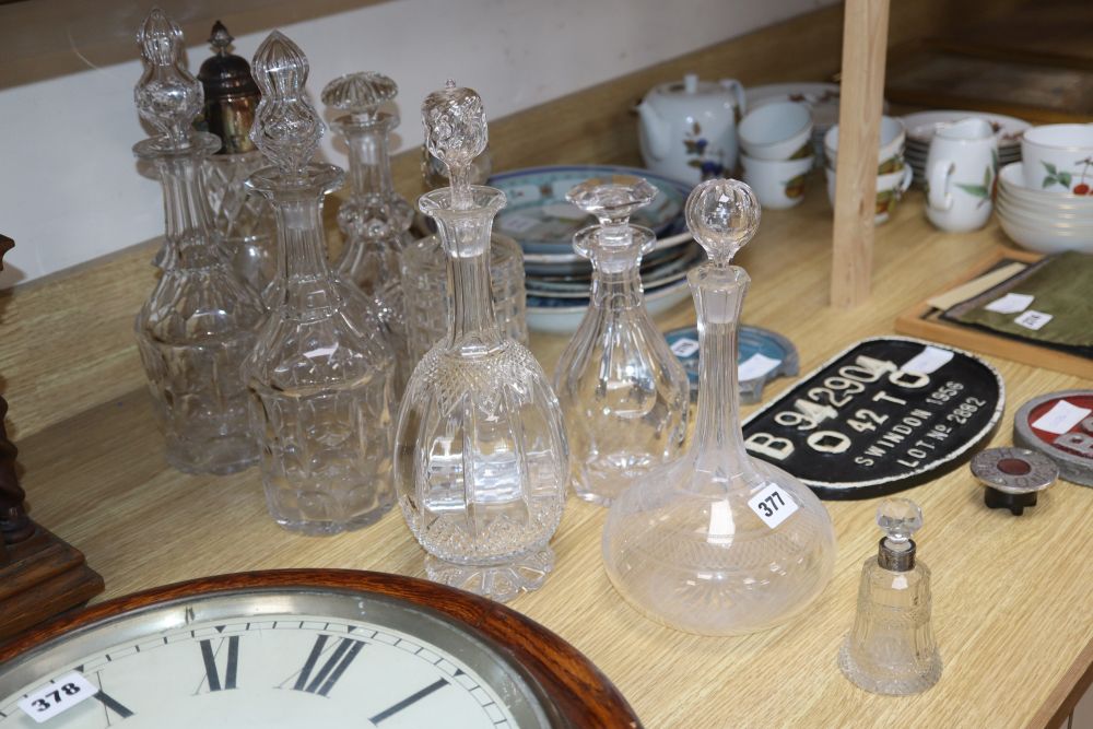A pair of cut glass decanters and five others